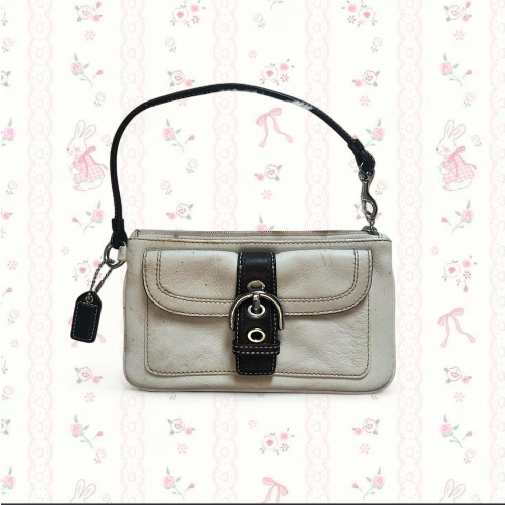Coach Hampton ivory leather wristlet with a brown buckle detail